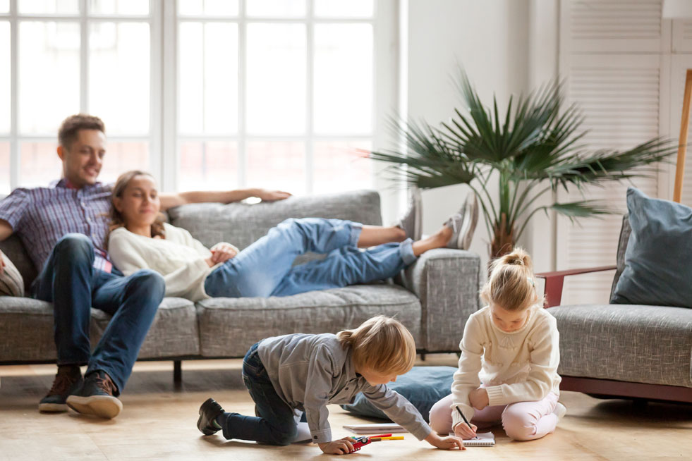 Family relaxing in the living room comfortably