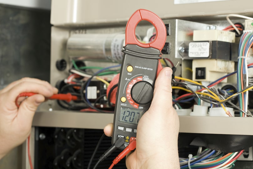 A Technician making repairs to a furnace