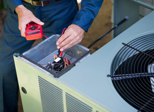 Air Conditioner Repairman checking an AC Unit